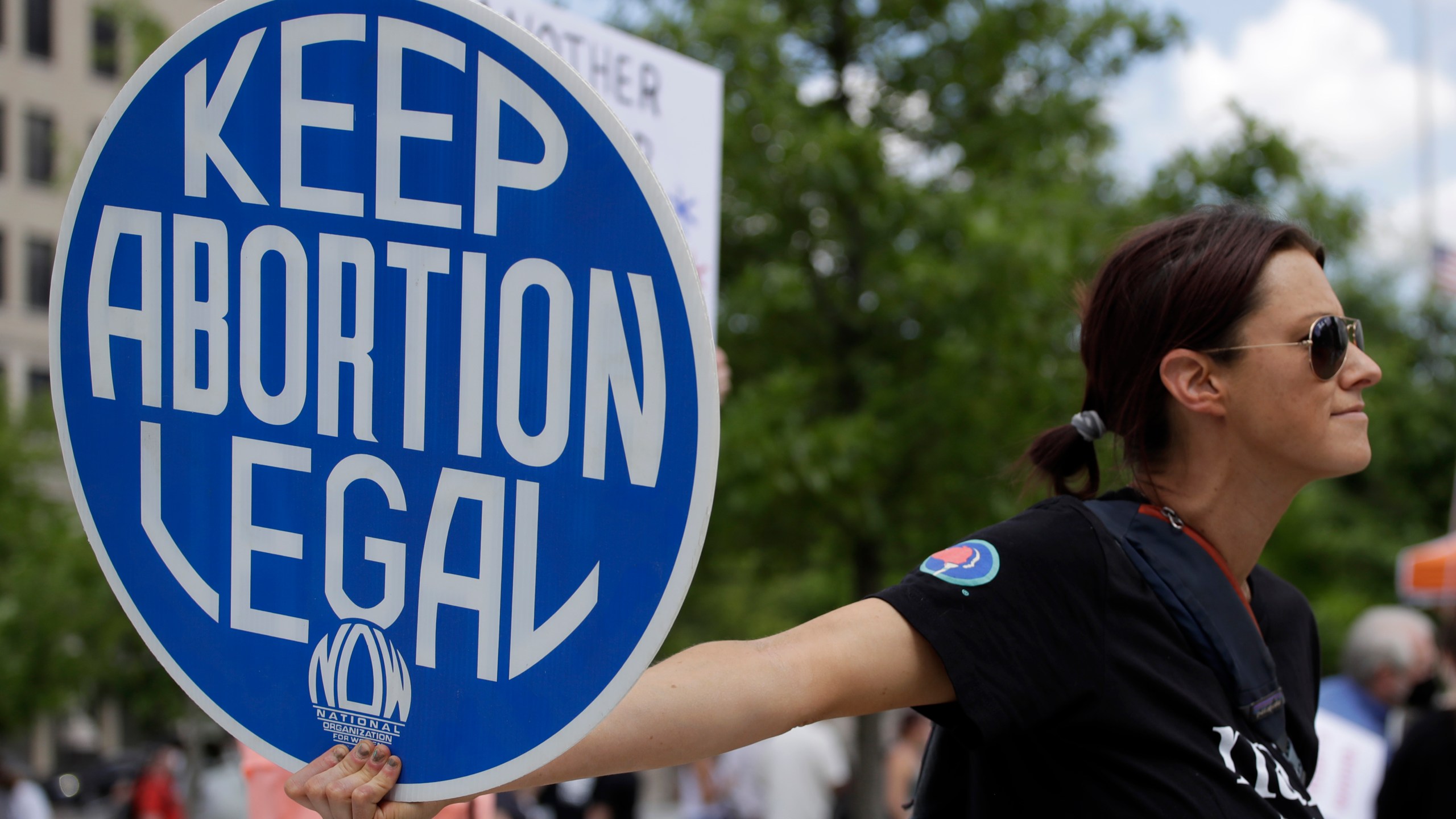 FILE - An abortion-rights demonstrator holds a sign during a rally, May 14, 2022, in Chattanooga, Tenn. On Monday, Jan. 8, 2024, more women joined a Tennessee lawsuit challenging the state's broad abortion ban that went into effect shortly after the U.S. Supreme Court overturned Roe v. Wade in 2022. (AP Photo/Ben Margot, File)