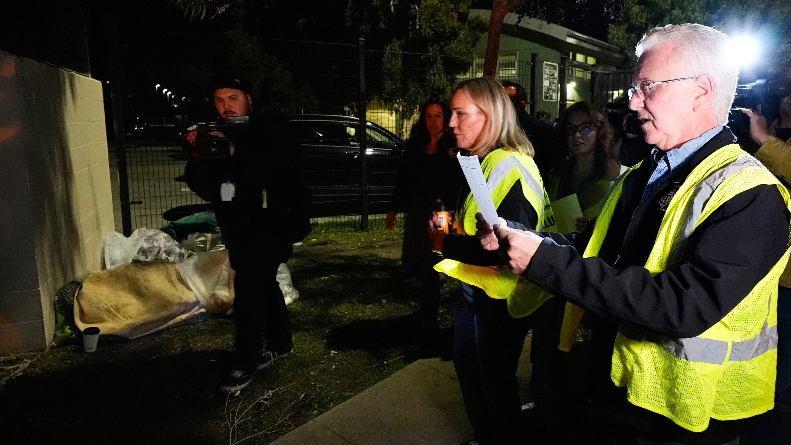 Los Angeles City Council President Paul Krekorian, right, joined by Supervisor Kathryn Barger, center, who represents the 5th supervisorial district of Los Angeles County, walks on the streets at the start of the annual homeless count in the North Hollywood section of Los Angeles Tuesday, Jan. 23, 2024. (AP Photo/Richard Vogel)