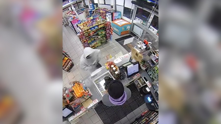 Police officer walks in 7-Eleven as armed robbery in progress