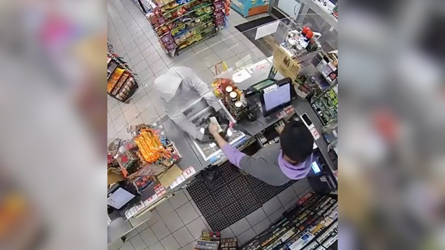 Police officer walks in 7-Eleven as armed robbery in progress