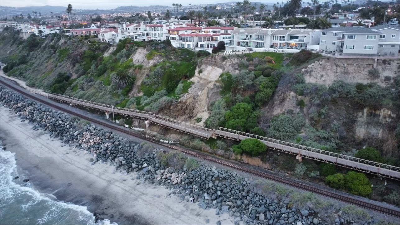 Aerial view shows the slumping hillside where a pedestrian bridge came loose in San Clemente, sending debris onto the train tracks below on Jan. 24, 2024. (Orange County Transit Authority via Katrina Foley)