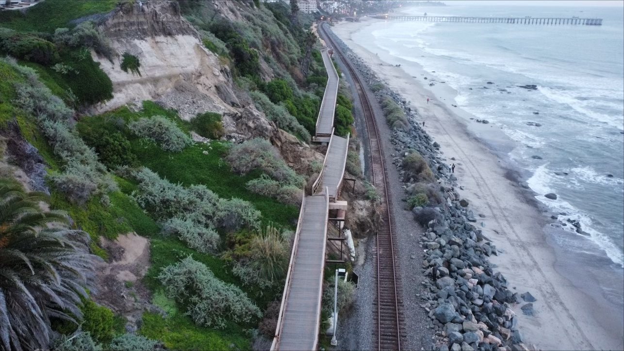 Aerial view shows the slumping hillside where a pedestrian bridge came loose in San Clemente, sending debris onto the train tracks below on Jan. 24, 2024. (Orange County Transit Authority via Katrina Foley)