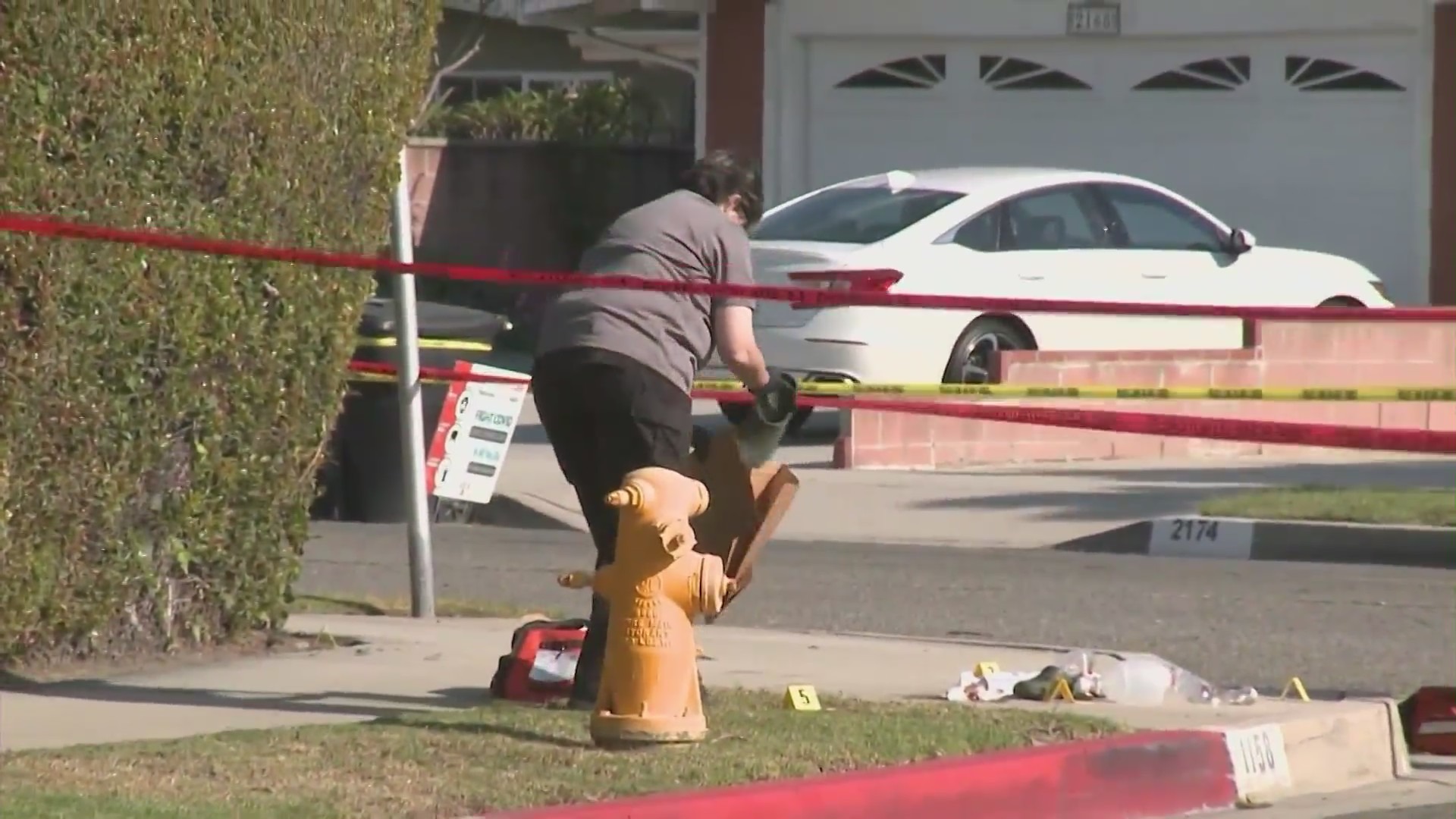 Anaheim Police Department officers outside Rahmatolah “David” Yaghoubi's home on May 31, 2021. (KTLA)