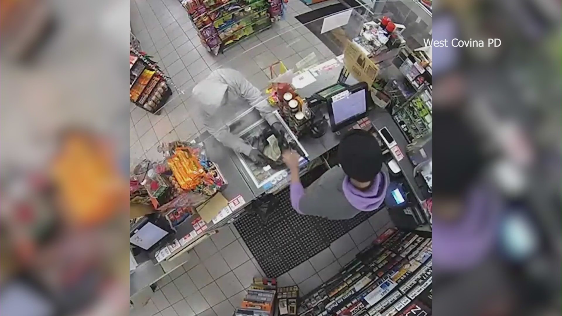 Cameras capture the moment a police officer coincidentally walks into a 7-Eleven during an armed robbery in West Covina on Jan. 17, 2024. (West Covina Police Department)