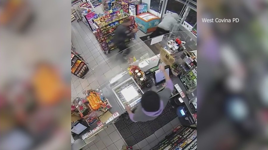 Cameras capture the moment a police officer coincidentally walks into a 7-Eleven during an armed robbery in West Covina on Jan. 17, 2024. (West Covina Police Department)