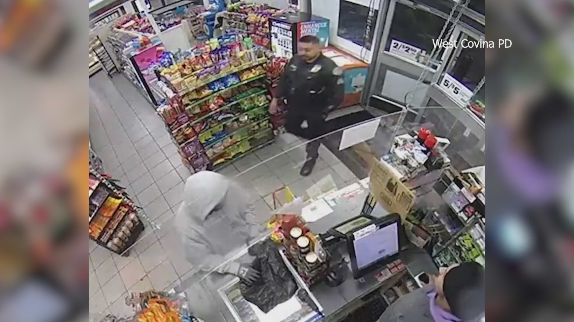 Cameras capture the moment a police officer coincidentally walks into a 7-Eleven during an armed robbery in West Covina on Jan. 17, 2024. (West Covina Police Department)