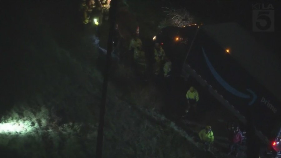 Amazon delivery truck stuck on hillside, threatening home below