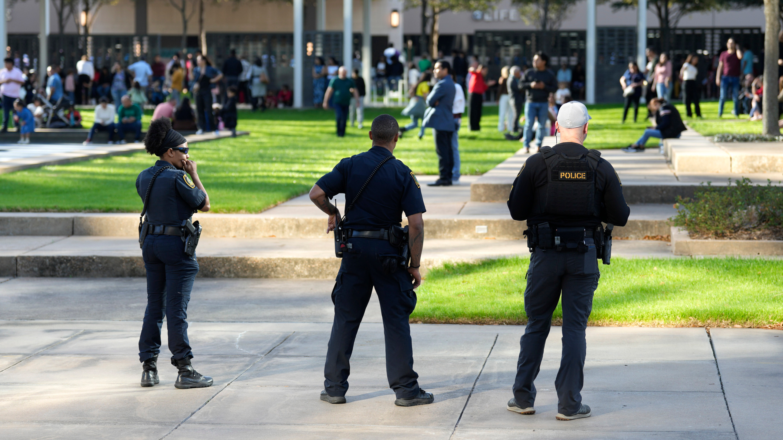 Houston Police officers watch over displaced churchgoers outside Lakewood Church, Sunday, Feb. 11, 2024, in Houston, after a reported shooting during a Spanish church service.