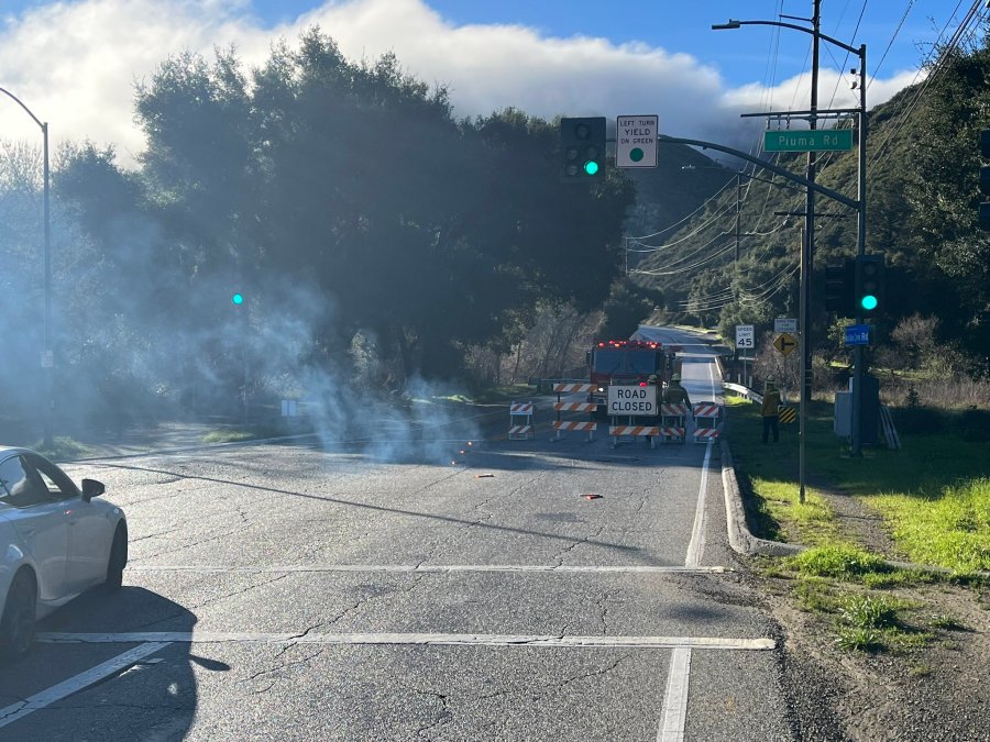 Dirt and boulders covering Malibu Canyon Road are seen in an image posted by the Los Angeles County Fire Department on Feb. 21, 2023.