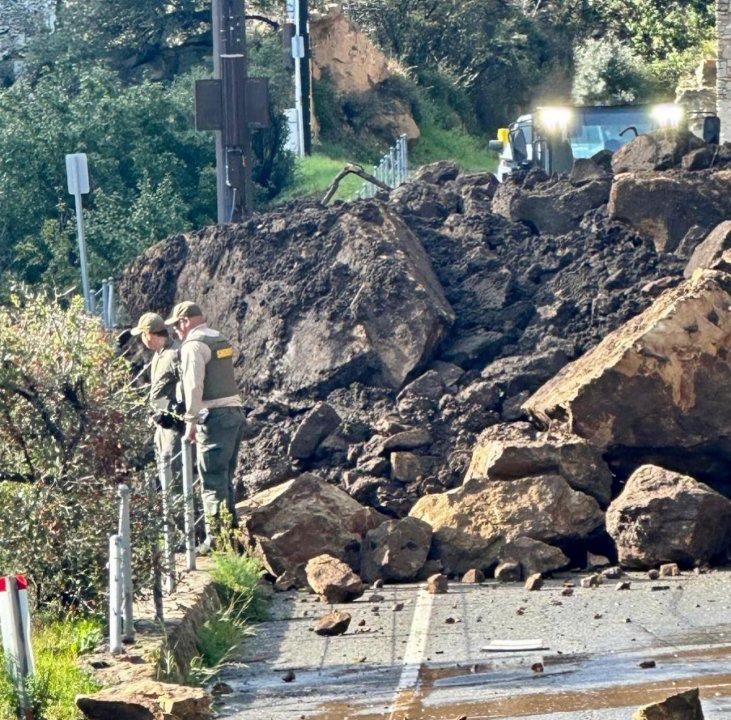 Dirt and boulders covering Malibu Canyon Road are seen in an image posted by the Los Angeles County Fire Department on Feb. 21, 2023.