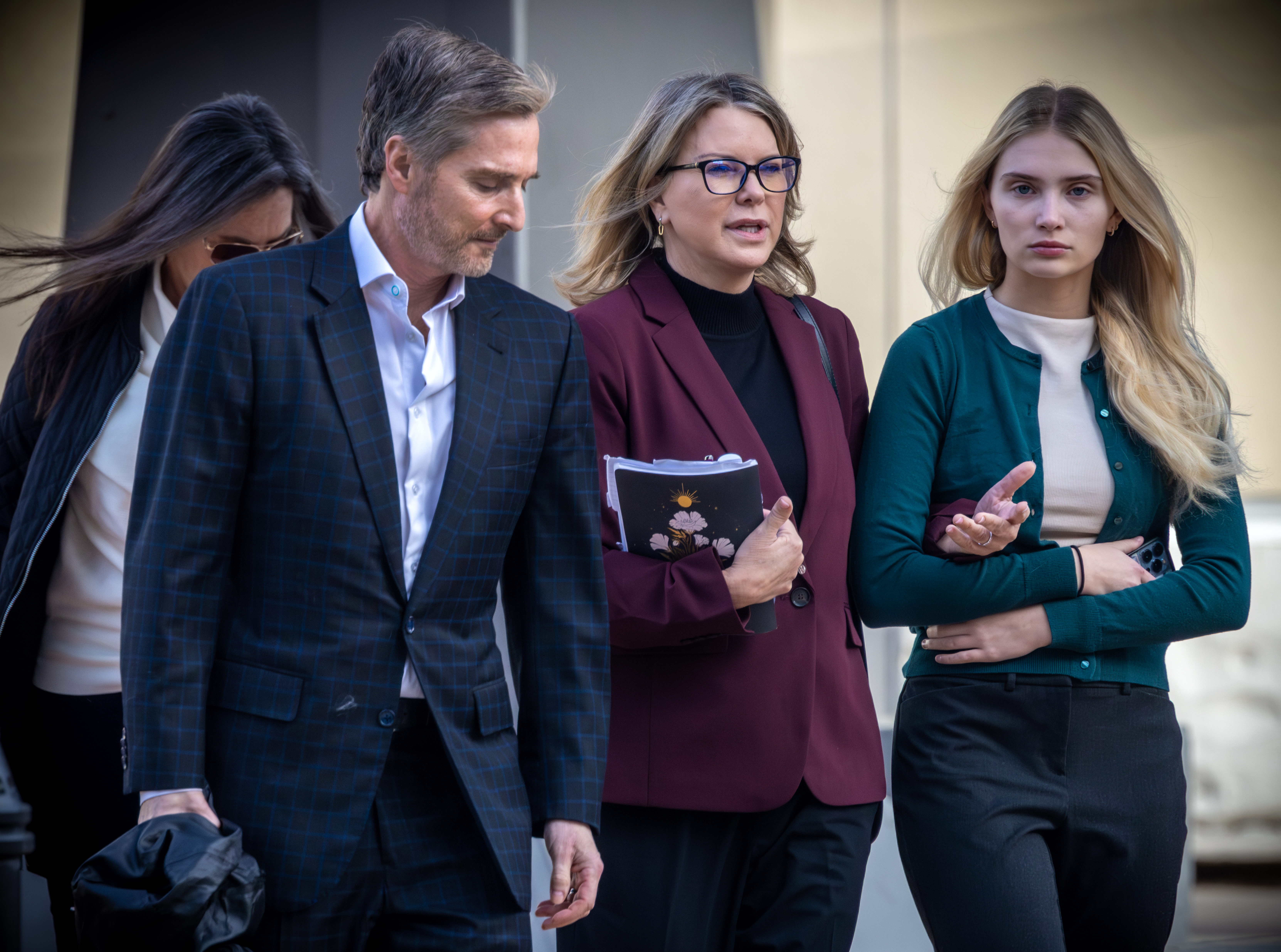 Rebecca Grossman, second from left, with her husband, Dr. Peter Grossman, left, and daughter heads to Van Nuys Courthouse West Van Nuys, CA. (Irfan Khan / Los Angeles Times via Getty Images)