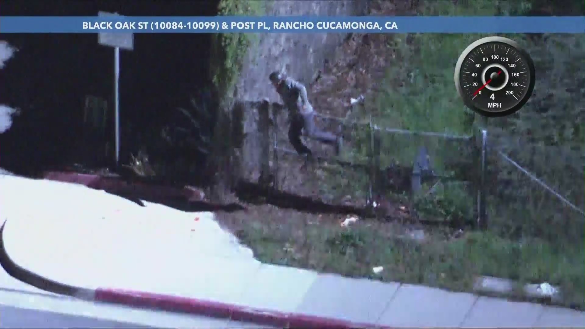 The male suspect jumping a fence after a fiery semi-truck pursuit on Feb. 21, 2024. (KTLA)