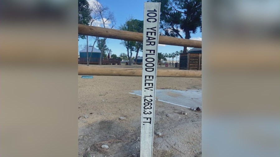 A marker on dry land indicates the 100-year floodplain elevation at Lake Elsinore — 1,263 feet. (KTLA)