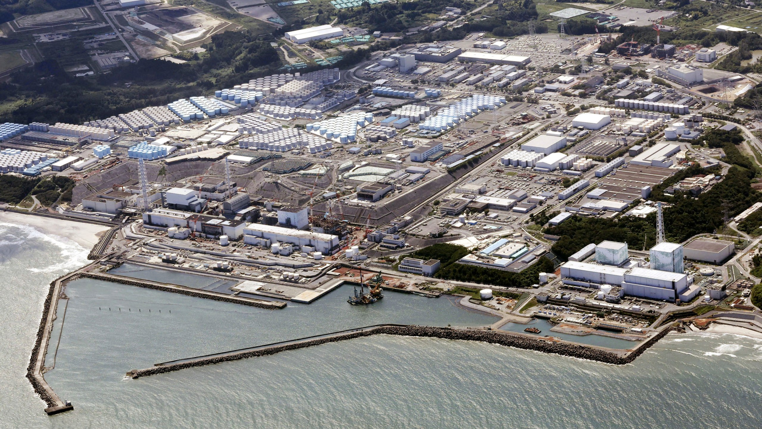FILE - This aerial view shows the Fukushima Daiichi nuclear power plant in Fukushima, northern Japan, on Aug. 24, 2023, shortly after its operator Tokyo Electric Power Company Holdings TEPCO began releasing its first batch of treated radioactive water into the Pacific Ocean. Japan on Monday, March 11, 2024, marked 13 years since a massive earthquake and tsunami hit the country’s northern coasts. (Kyodo News via AP, File)