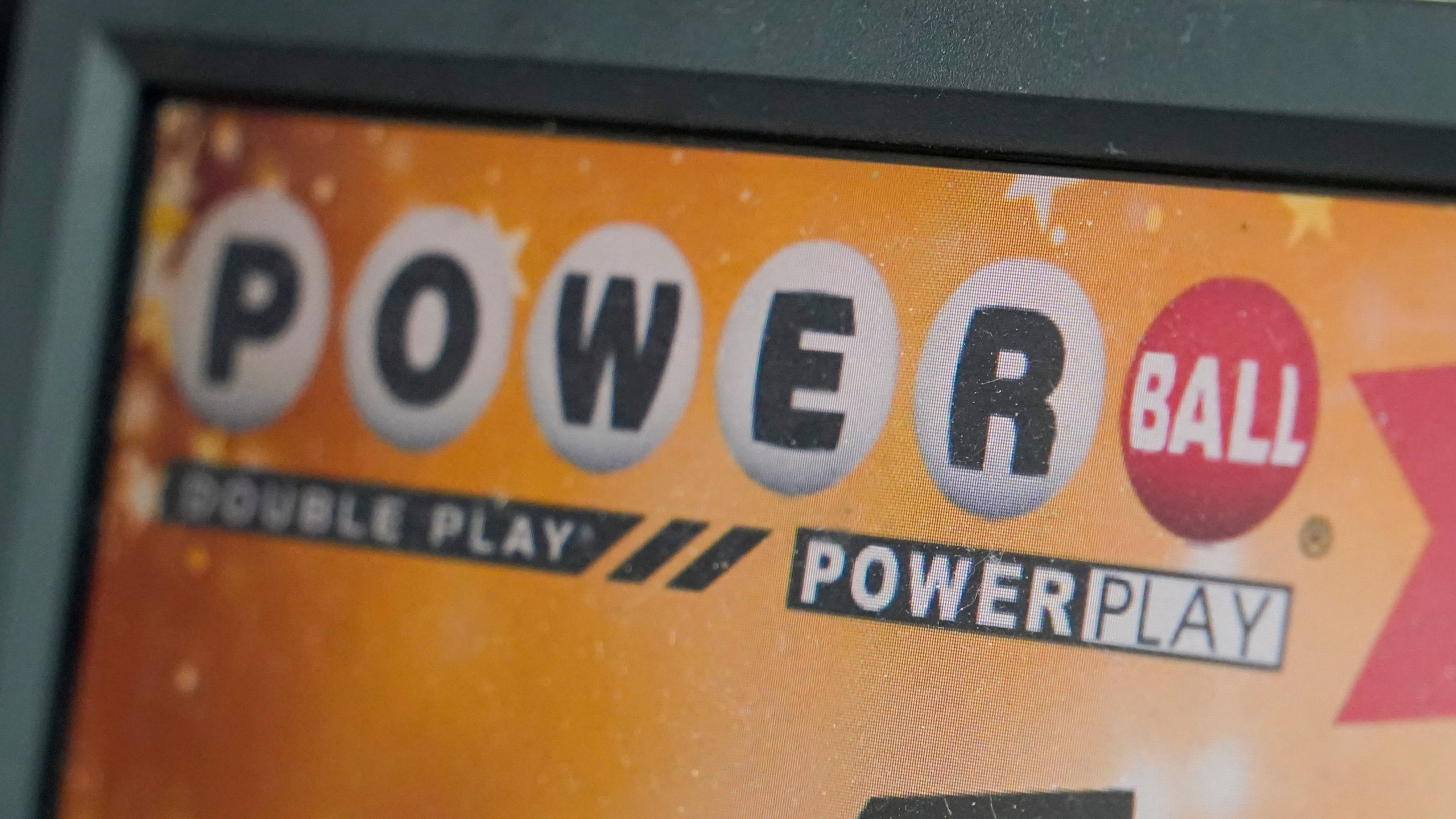 FILE - A display panel advertises tickets for a Powerball drawing at a convenience store, Nov. 7, 2022, in Renfrew, Pa. There is an $865 million Powerball jackpot up for grabs Wednesday night, March 27, 2024. (AP Photo/Keith Srakocic, File)