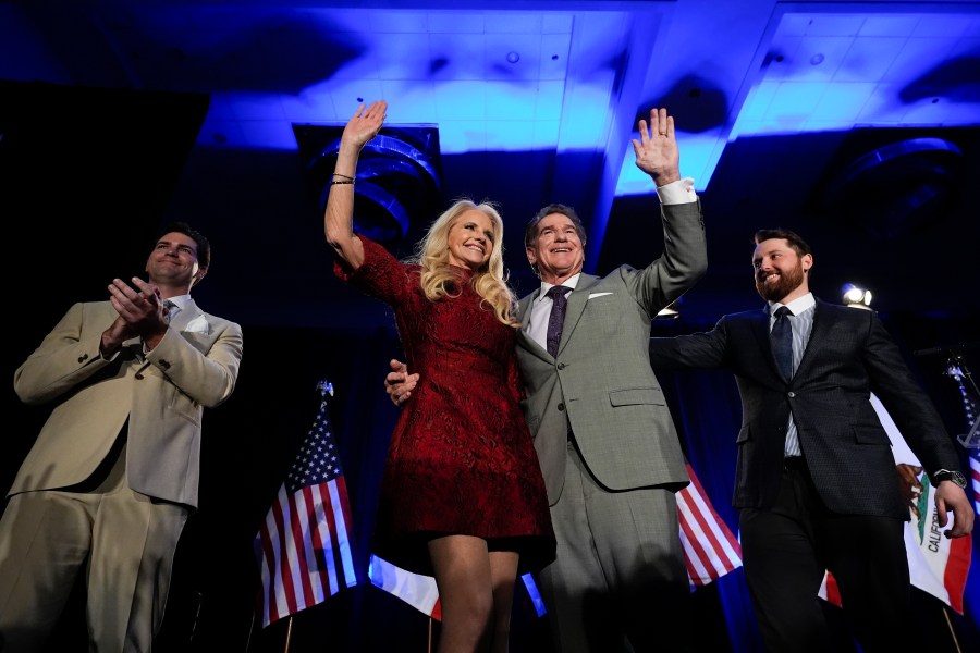 Republican U.S. Senate candidate Steve Garvey, center right, hugs his wife Candace standing next to his sons Ryan, left, and Sean during his election night party, Tuesday, March 5, 2024, in Palm Desert, Calif.