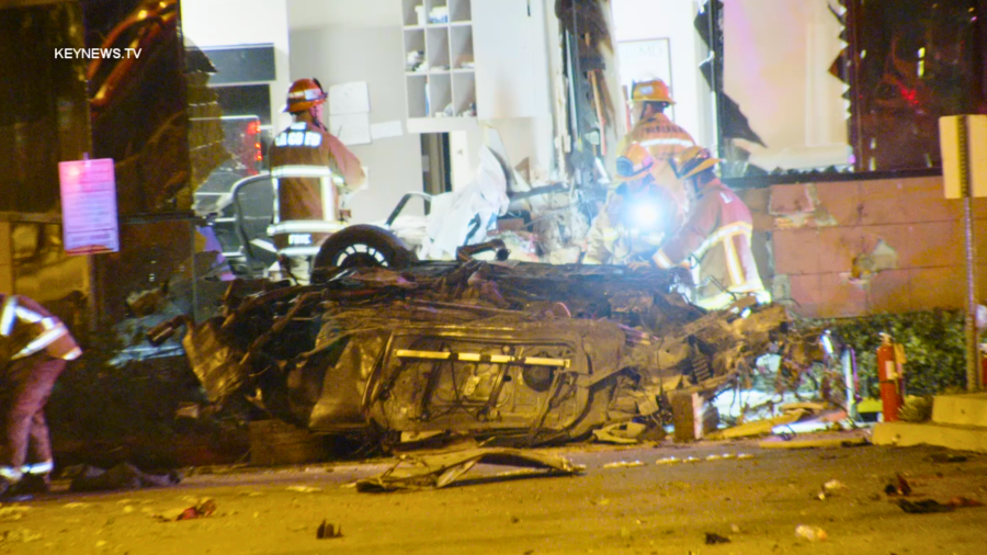 Emergency personnel respond to a car into a building in Pomona on March 18, 2024.