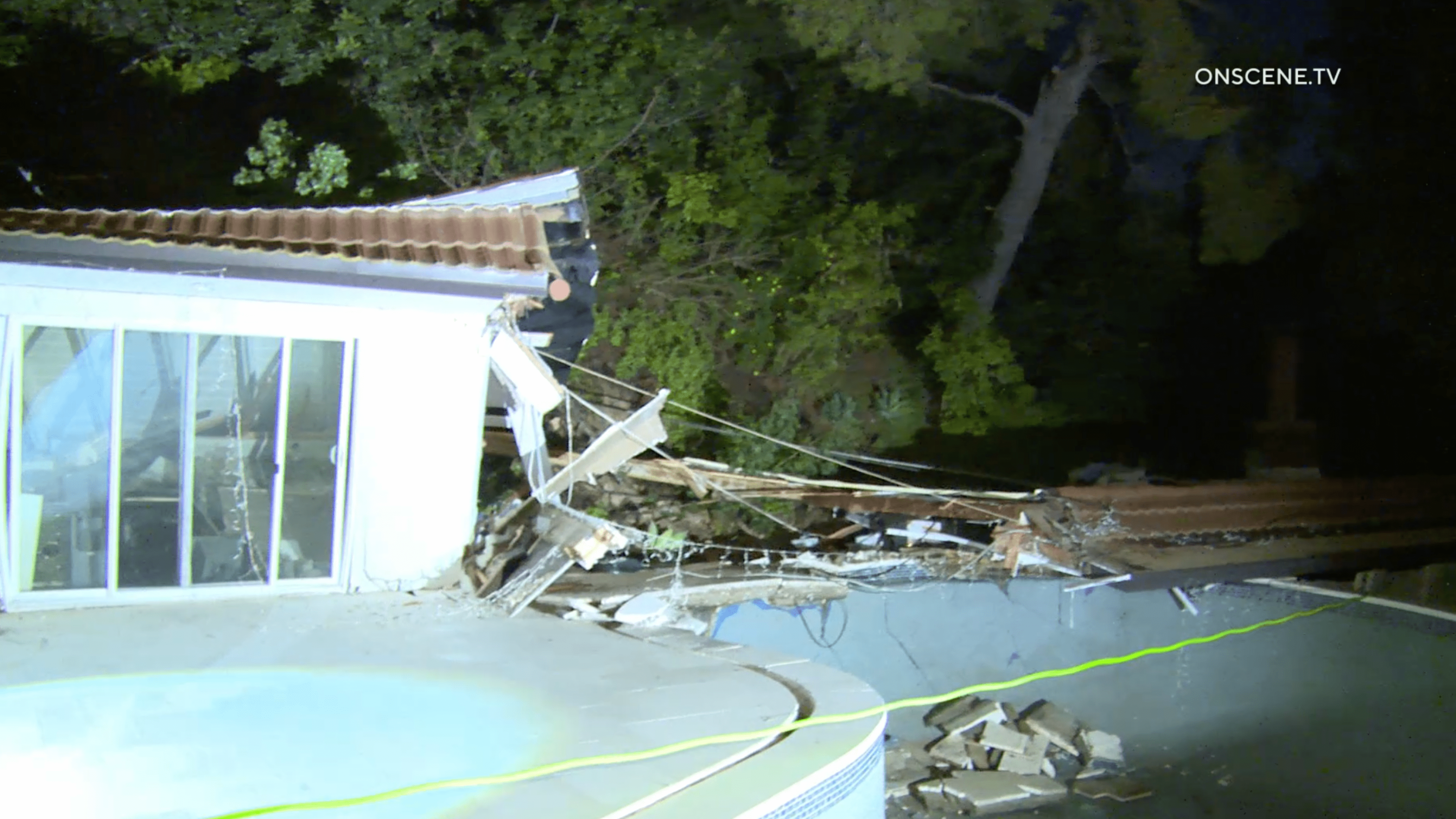 A landslide tore through the backyard of a home in Sherman Oaks on March 13, 2024.