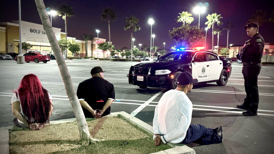 Retail theft suspects are seen in handcuffs in Upland on March 19, 2024.