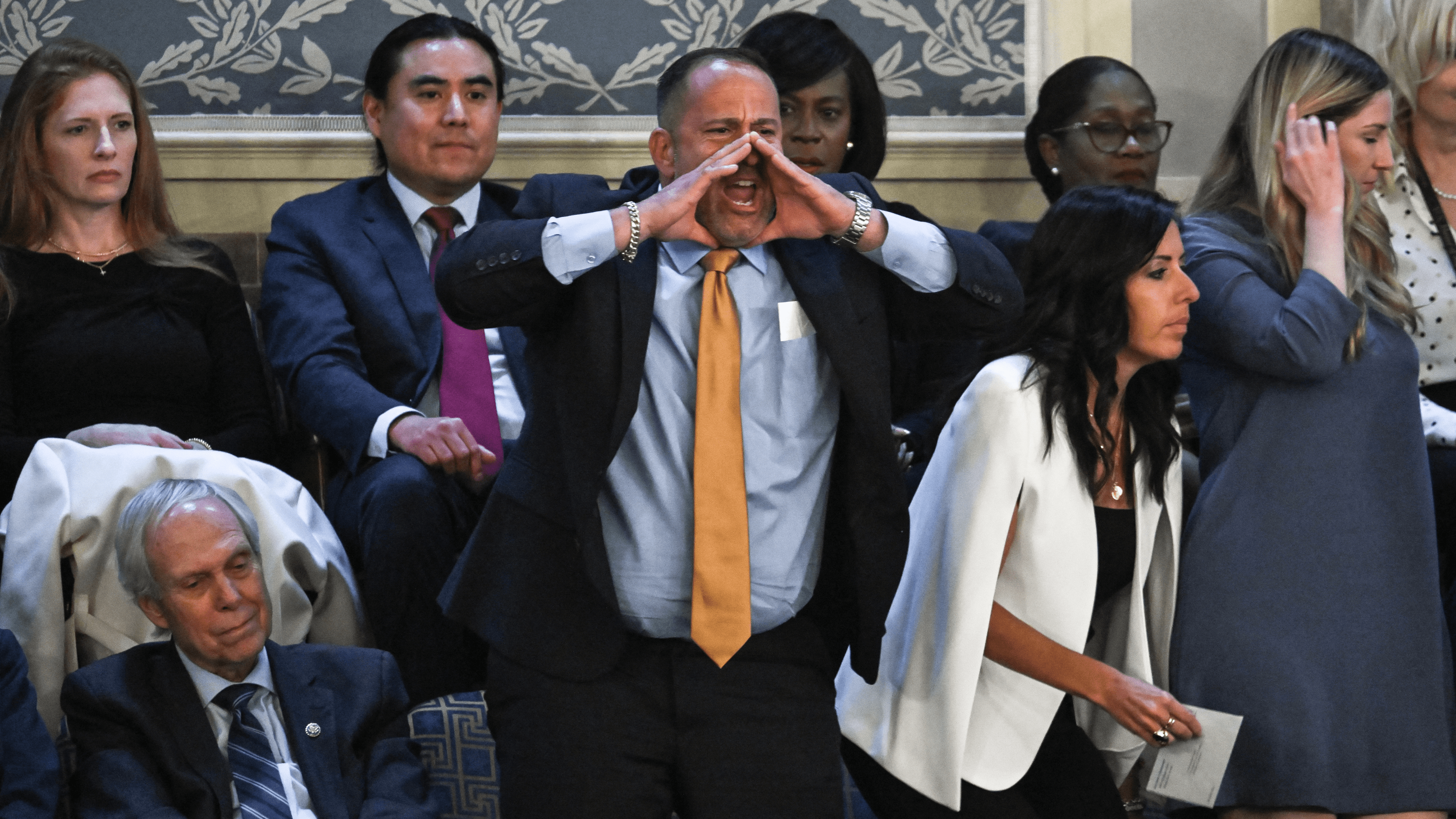 A man identified by Axios as Steven Nikoui shouts in protest from the upper gallery of the audience as U.S. President Joe Biden delivers the State of the Union address in Washington, DC, on March 7, 2024.