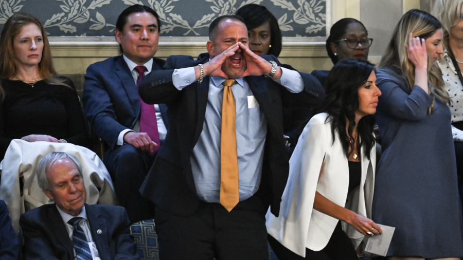 A man identified by Axios as Steven Nikoui shouts in protest from the upper gallery of the audience as U.S. President Joe Biden delivers the State of the Union address in Washington, DC, on March 7, 2024.