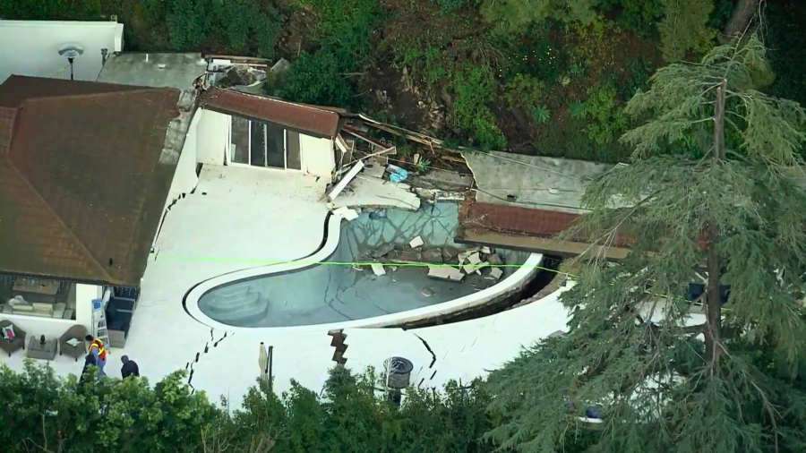 A landslide tore through the backyard of a home in Sherman Oaks on March 13, 2024.