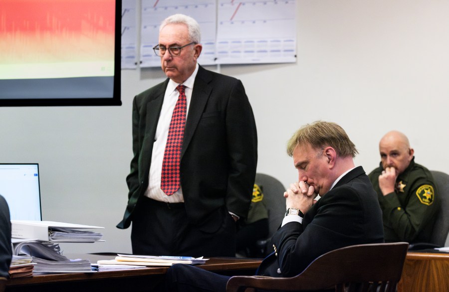 SANTA ANA, CA - November 28: Attorney Jack Earley, standing, and his client Eric Scott Sills listen to Sills 911 call from the day of his wifes death during opening statements in Orange County Superior Court in Santa Ana, CA on Tuesday, November 28, 2023. Eric Scott Sills is on trial for the death of his wife, Susann Sills. (Photo by Paul Bersebach/MediaNews Group/Orange County Register via Getty Images)