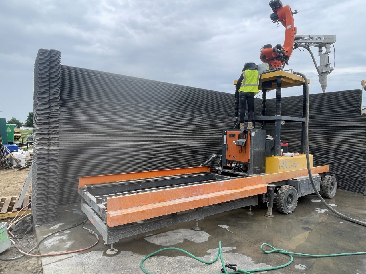 A robotic 3D printing arm is laying the walls of a fire-resistant ADU in Walnut, California. (RIC Technology)