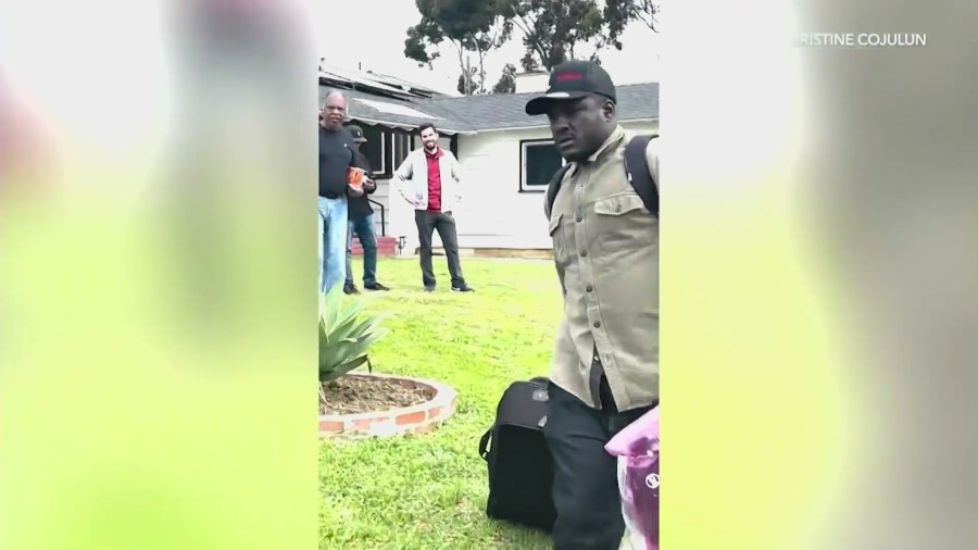 The suspect, John Ross, being confronted by neighbors who said he's been terrorizing the Gardena community for years. (Christine Cojulun)