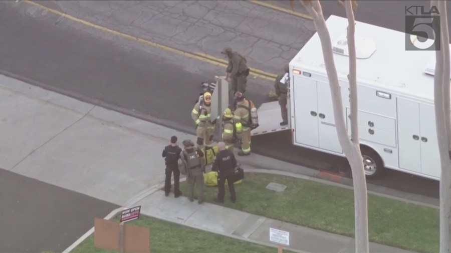 Bomb squad members prepare robots to inspect a Wells Fargo bank in Fullerton after a bomb threat on March 26, 2024. (KTLA)