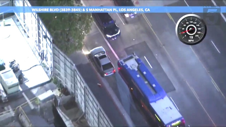 The suspect squeezes next to a large bus on the wrong side of the road during a reckless pursuit on March 29, 2024. (KTLA)