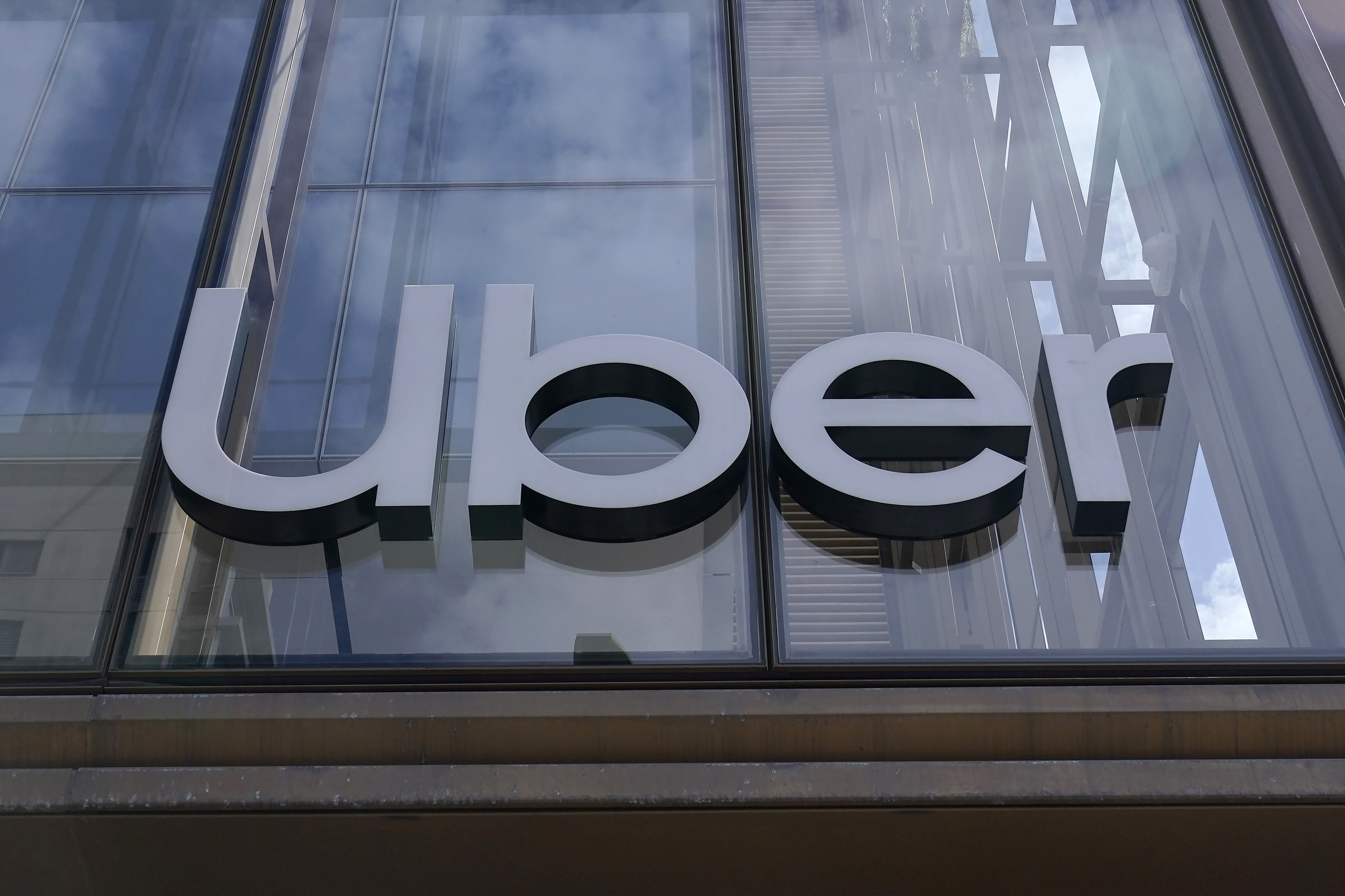 FILE - An Uber sign is displayed at the company's headquarters in San Francisco, Sept. 12, 2022. A failed Australian taxi industry disruptor has on Tuesday, April 2, 2024, begun its law suit against Uber claiming the U.S. giant began illegally operating ride sharing in Australia to gain an unfair advantage over competitors. (AP Photo/Jeff Chiu, File)