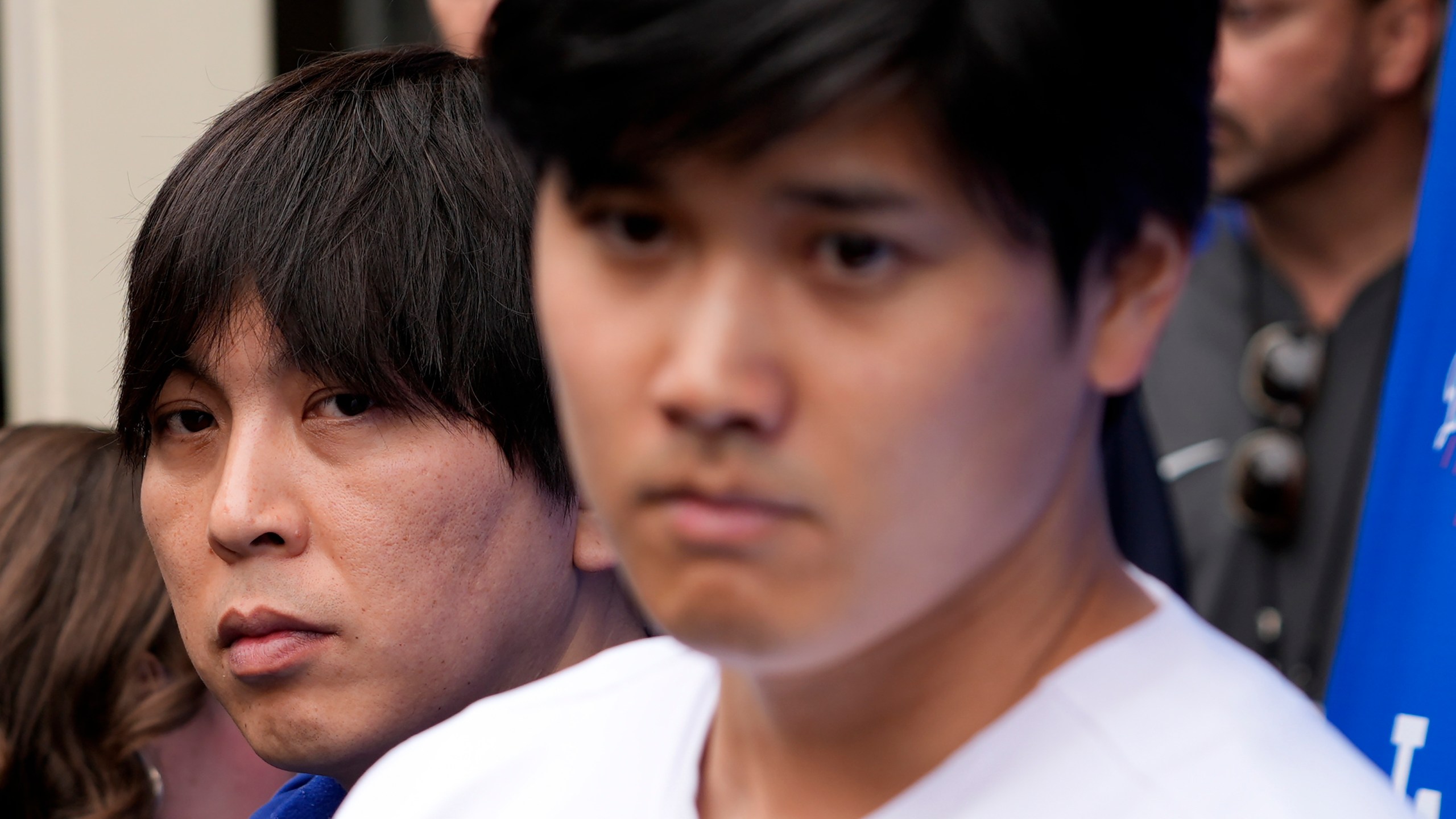 FILE - Ippei Mizuhara stands next to Japanese baseball star Shohei Ohtani and translates during an interview at Dodger Stadium on Feb. 3, 2024. The former longtime interpreter for Los Angeles Dodgers star Shohei Ohtani has been charged with federal bank fraud for crimes involving gambling debts and theft of millions of dollars from the slugger. Federal authorities announced the development Thursday, April 11, at a press conference in Los Angeles. (AP Photo/Richard Vogel, File)