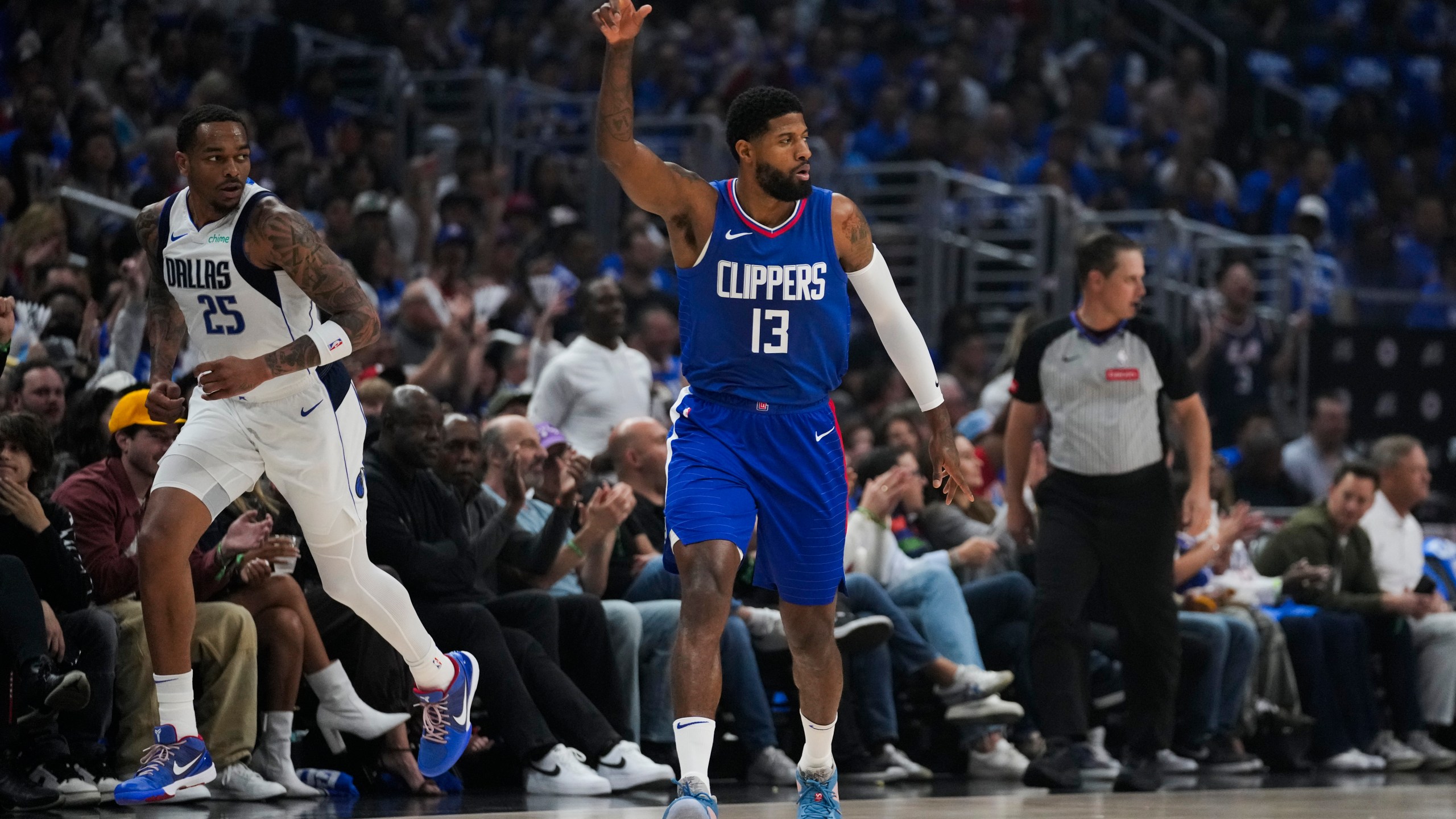 LA Clippers forward Paul George (13) celebrates after making a 3-pointer during the first half of Game 1 of an NBA basketball first-round playoff series against the Dallas Mavericks in Los Angeles, Sunday, April 21, 2024. (AP Photo/Ashley Landis)