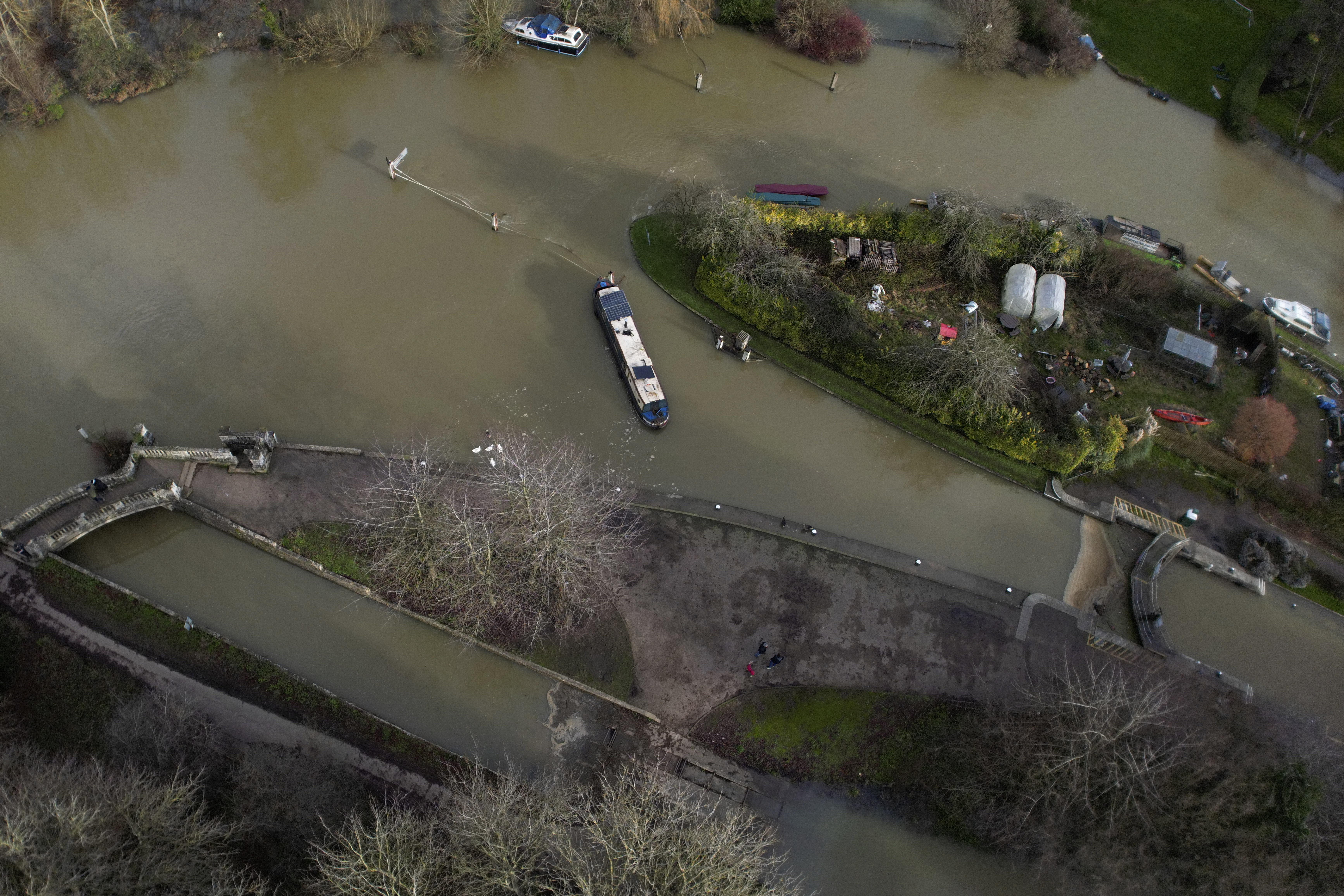 FILE - A narrow boat sits in the floods of the river Thames in Oxford, England, Sunday, Jan. 7, 2024. Britain was hit by heavy rainfall last week following storm Henk, which led to flooding in parts of the UK. Europe is the fastest-warming continent and its temperatures are rising at roughly twice the global average, two top climate monitoring organizations reported Monday, April 22, 2024, warning of the consequences for human health, glacier melt and economic activity. (AP Photo/Frank Augstein, File)