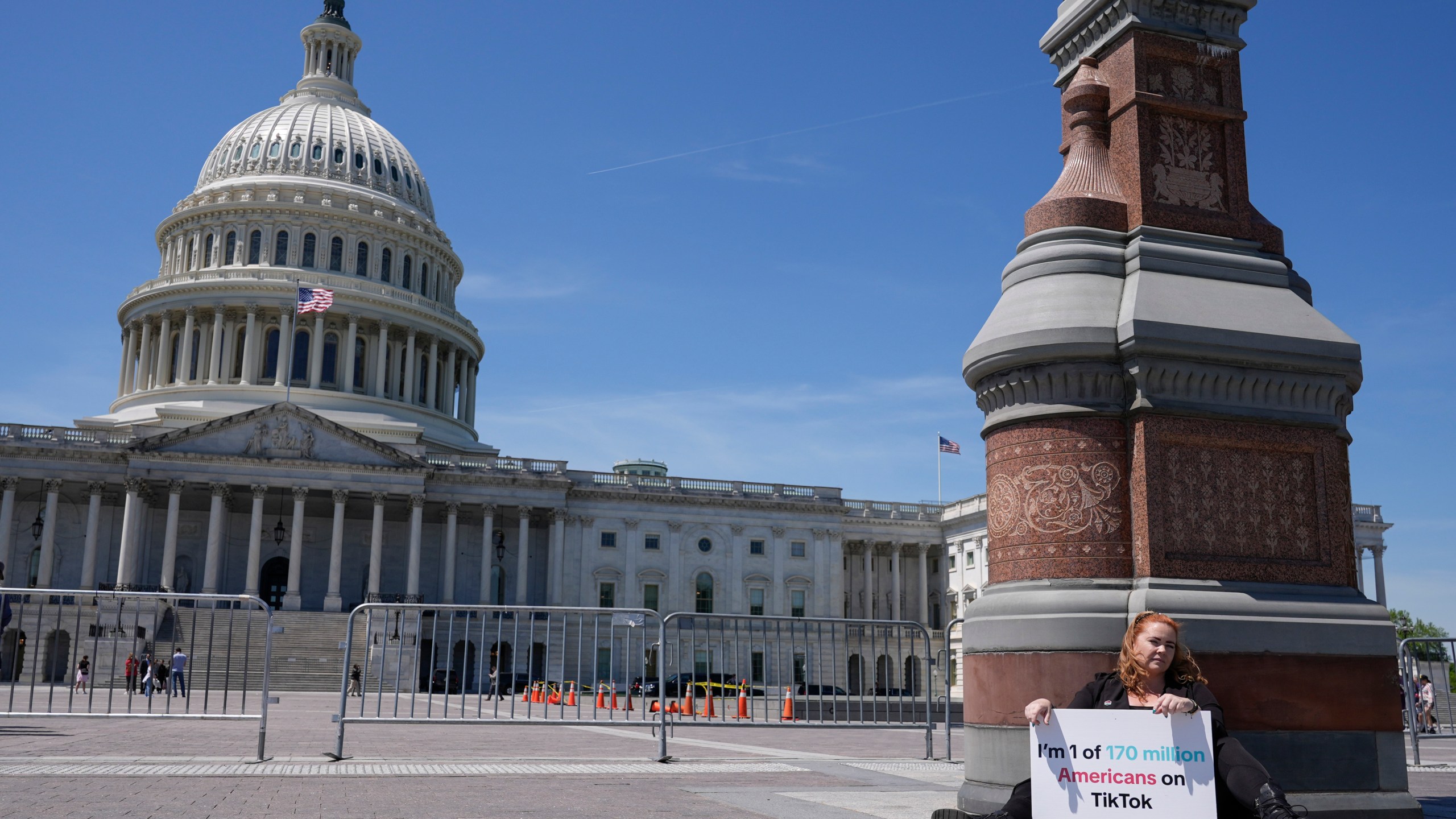 Jennifer Gay, a TikTok content creator, sits outside the U.S. Capitol, Tuesday, April 23, 2024, in Washington as Senators prepare to consider legislation that would force TikTok’s China-based parent company to sell the social media platform under the threat of a ban, a contentious move by U.S. lawmakers. (AP Photo/Mariam Zuhaib)