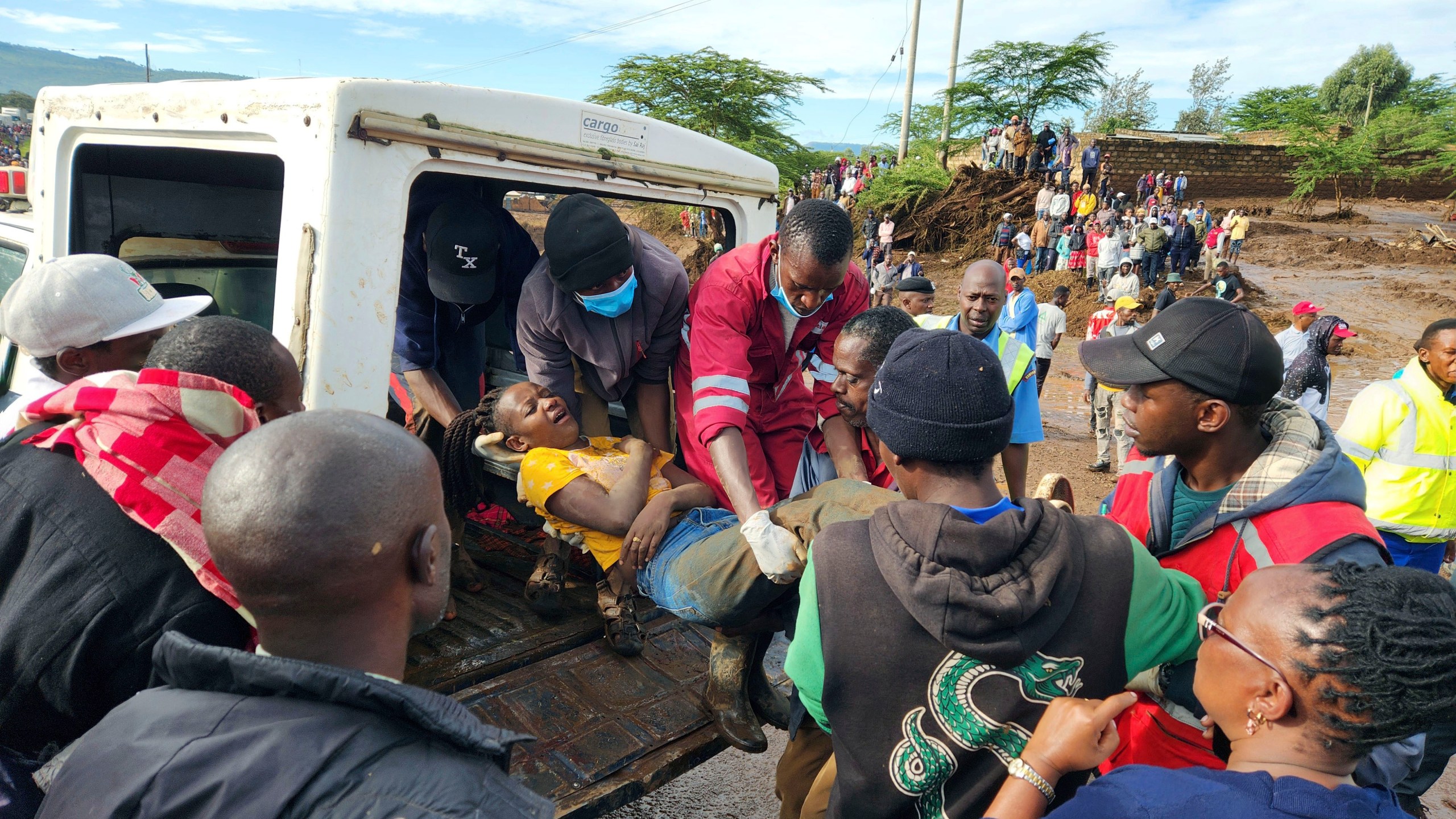Paramedics carry an injured woman after a dam burst, in Kamuchiri Village Mai Mahiu, Nakuru County, Kenya, Monday, April. 29, 2024. Police in Kenya say at least 40 people have died after a dam collapsed in the country's west. (AP Photo)