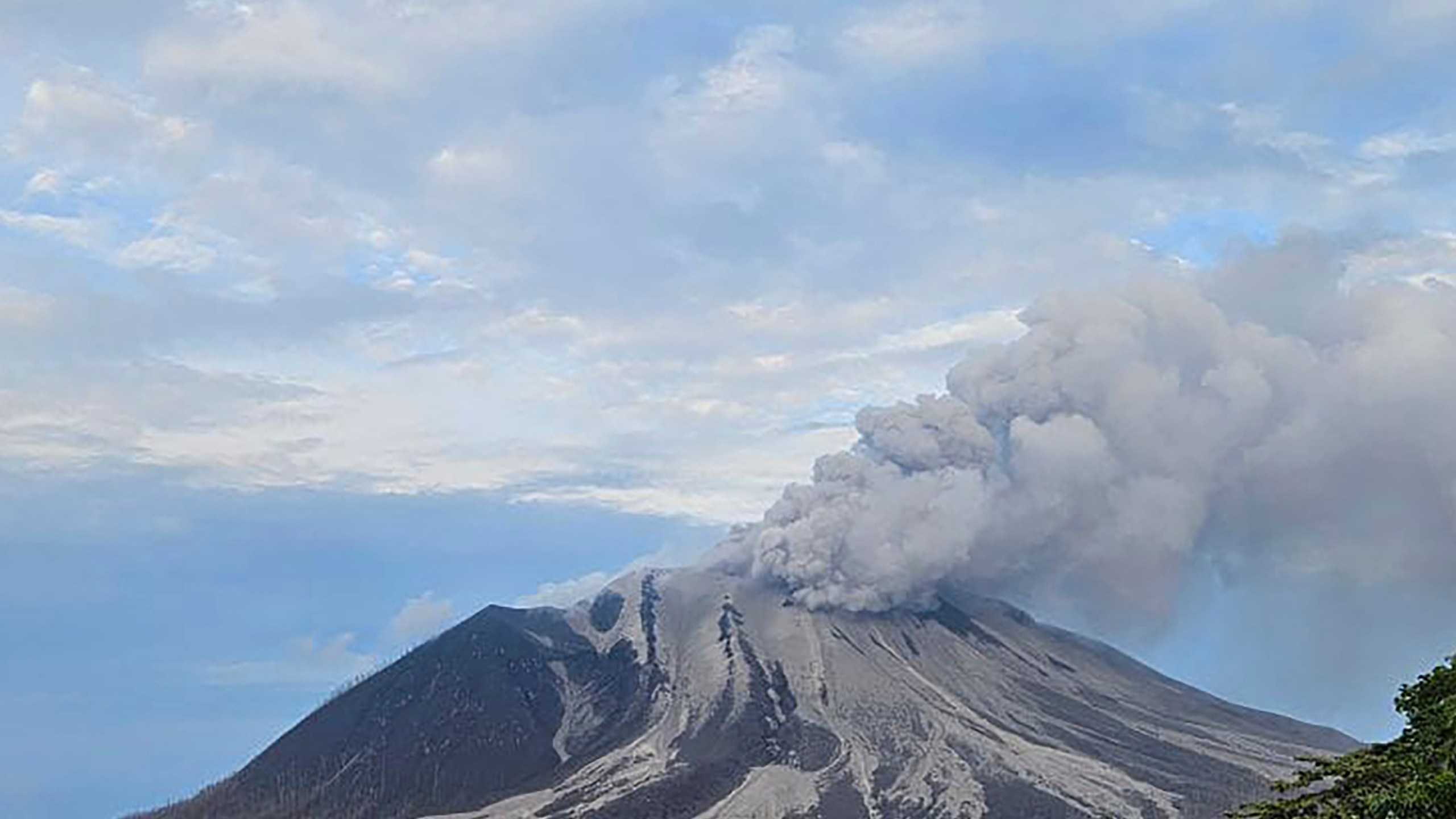 In this photo released by the Vulcanology and Geological Disaster Mitigation Center (PVMBG) of the Indonesian Ministry of Energy and Mineral Resources, Mount Ruang releases volcanic materials during its eruption on Wednesday, May 1, 2024, on Sulawesi Island, Indonesia. Indonesia's Mount Ruang volcano erupted Tuesday for a second time in two weeks, spewing ash almost 2 kilometers (more than a mile) into the sky, closing an airport and peppering nearby villages with debris. (PVMBG via AP Photo)