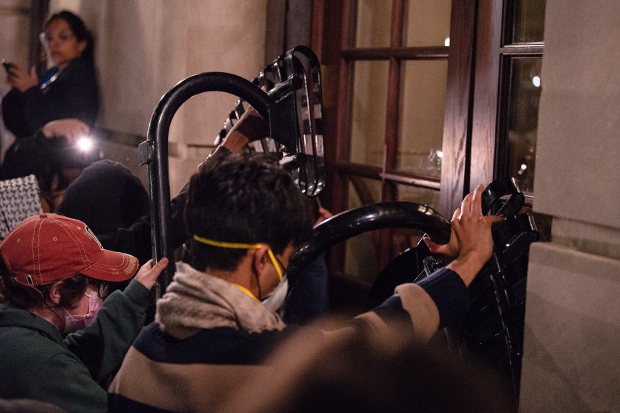 Students with the Gaza solidarity encampment block the entrance of Hamilton Hall at Columbia University after taking over it on Tuesday, April 30, 2024 in New York. Columbia Students for Justice in Palestine called for mobilization close to midnight. (Marco Postigo Storel via AP)