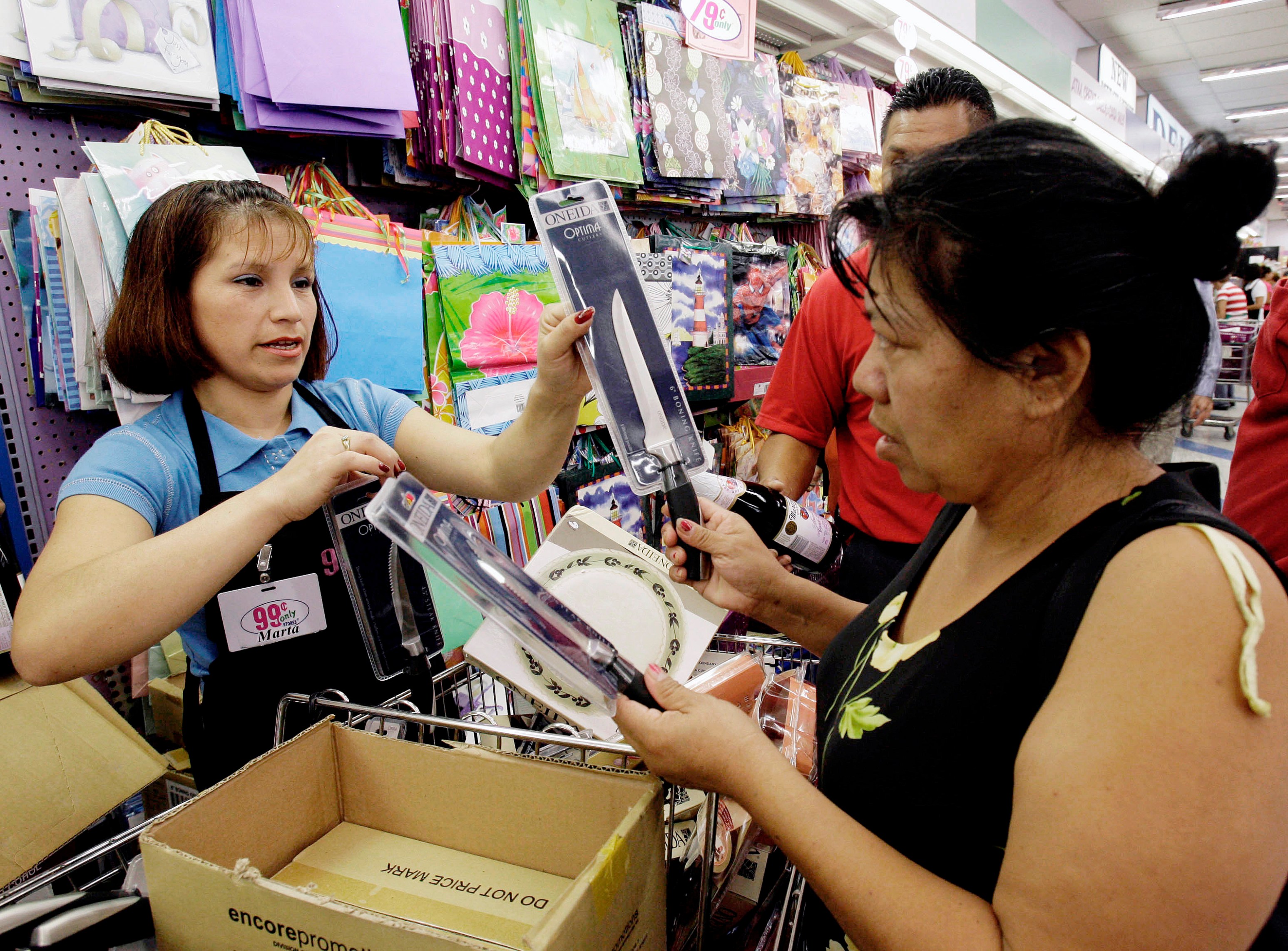 Marta Lara,left, helps Anita Hernandez at 99 Cent Store, in Los Angeles Monday, Sept 8, 2008. The discount retailer announced Monday the first price increase in the chain's 26-year history by raising the cost of household items, food and other items by almost a penny. The company blamed rising inflation, food and energy prices for the new 99.99 cent price. (AP Photo/Nick Ut)