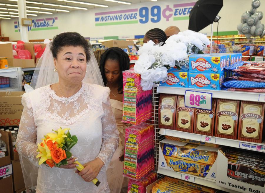 Gwen Whitmore waits for her 99 cent wedding ceremony at the 99 cent store in Los Angeles on September 9, 2009. The budget supermarket chain helped nine happy California couples beat the recession blues by offering cut-price wedding ceremonies -- for just 99 cents each. The 99 Cents Only Stores chain is picking up the tab for nine couples at its branch on Sunset Boulevard in the heart of Hollywood on Wednesday to mark the ninth day of the nine month in 2009. After getting hitched, the nine couples were handed 99 dollars and 99 cents in cash before being whisked off to an undisclosed "famous romantic Los Angeles" location. AFP PHOTO/Mark RALSTON (Photo credit should read MARK RALSTON/AFP via Getty Images)