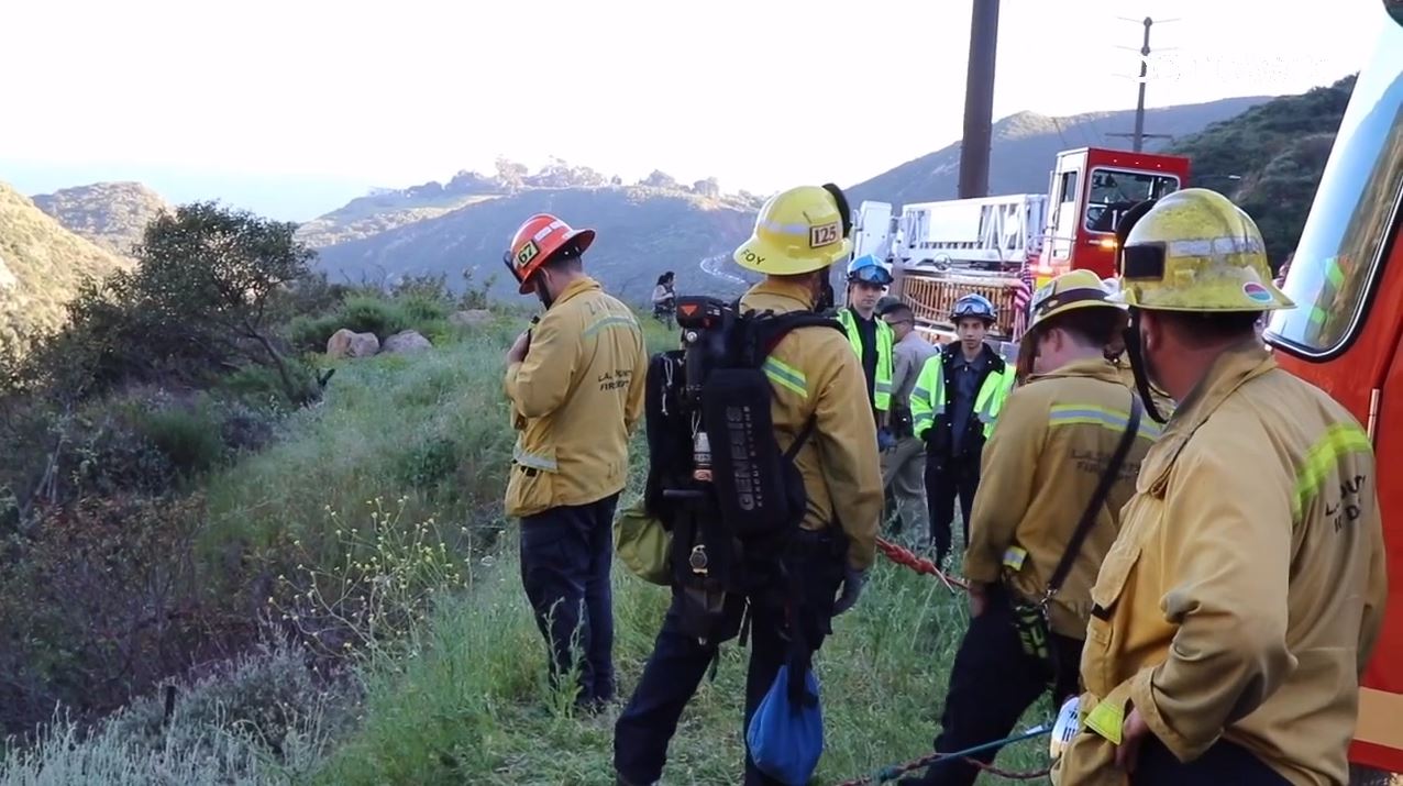 Crews descended down a Malibu cliffside after a driver was killed in a crash on April 3, 2024. (OC Hawk)