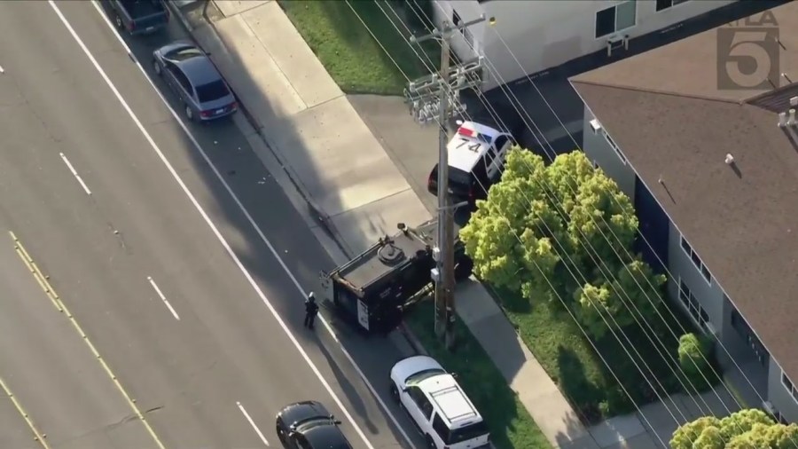 Police officers and SWAT Team members surround a housing complex after a 13-year-old boy was shot to death in Anaheim on April 17, 2024. (KTLA)