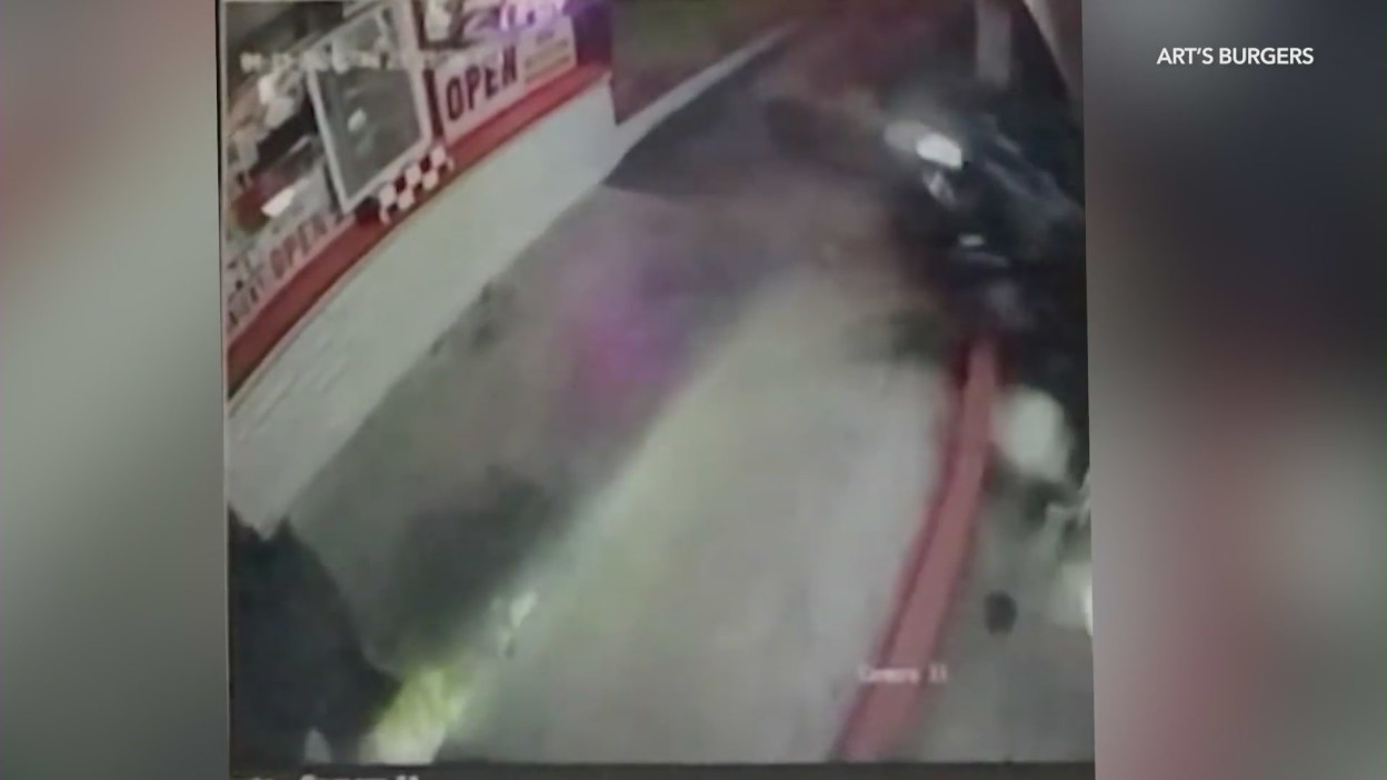 Security video shows the moment before a police car jumps the curb and crashes into Art's Burgers in El Monte on April 11, 2024. (KTLA)