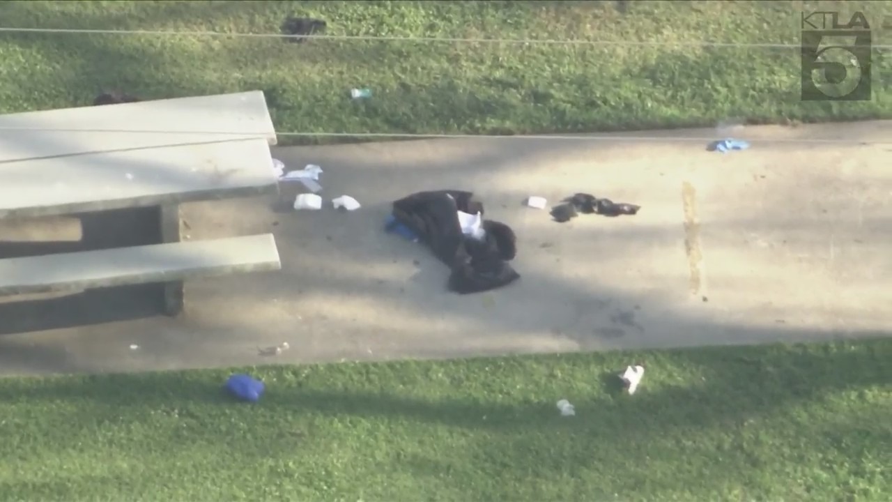 Fallen debris near a Long Beach park bench was isolated by authorities after a man was fatally shot by police on April 17, 2024. (KTLA)