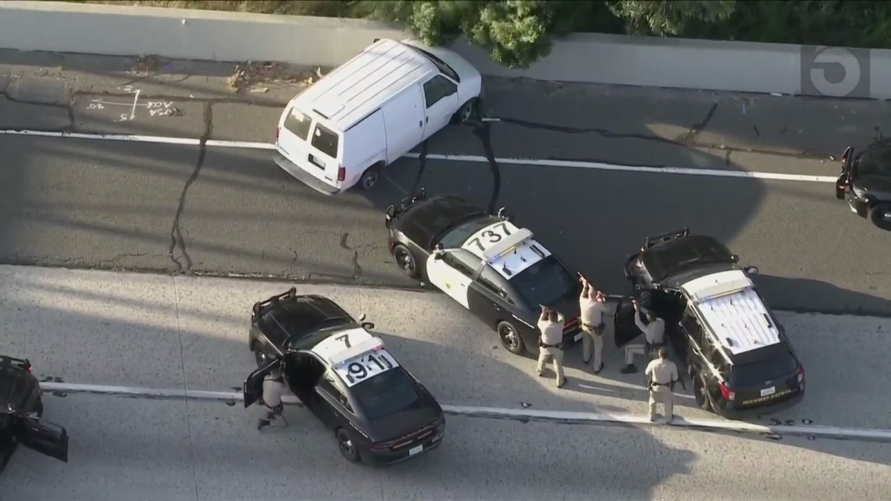 Officers surrounded the van after a successful second PIT maneuver on the 91 Freeway was successful. (KTLA)