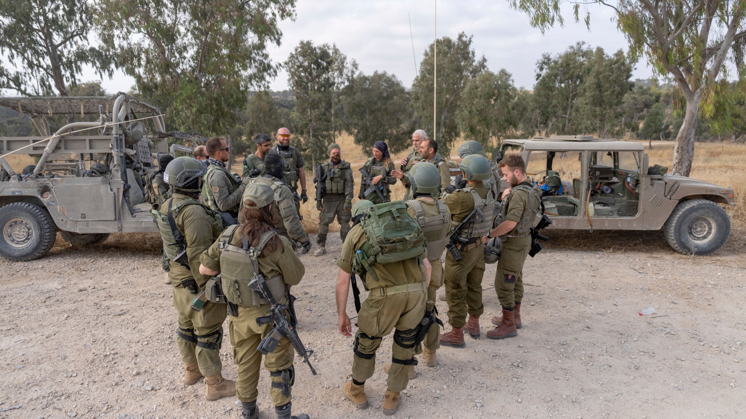 Israeli soldiers gather near the Israeli-Gaza border in southern Israel before they enter Gaza Strip, Wednesday, May 1, 2024. (AP Photo/Ohad Zwigenberg)