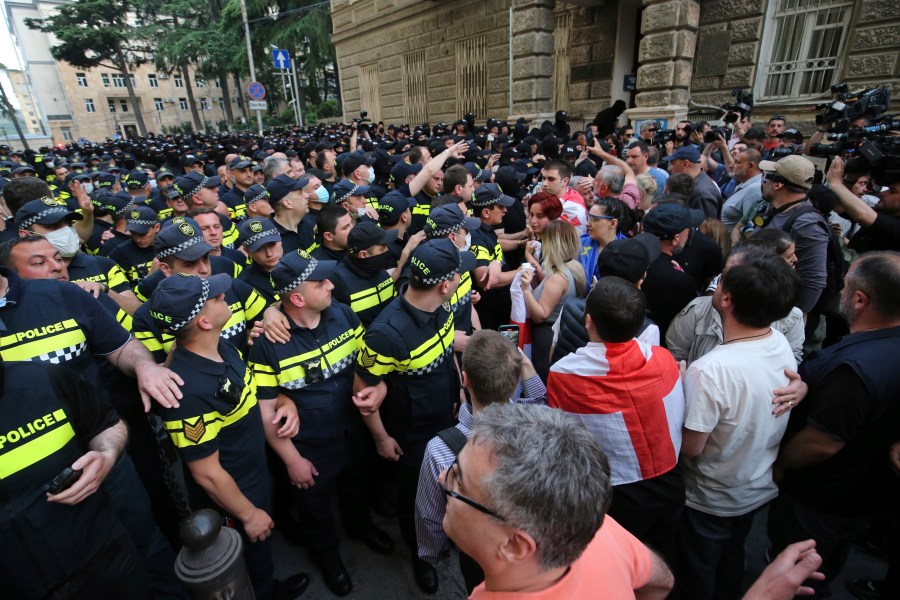Police face demonstrators during an opposition protest against "the Russian law" near the Parliament building in Tbilisi, Georgia, on Wednesday, May 1, 2024. Protesters denounce the bill as "the Russian law" because Moscow uses similar legislation to stigmatize independent news media and organizations critical of the Kremlin. (AP Photo/Zurab Tsertsvadze)
