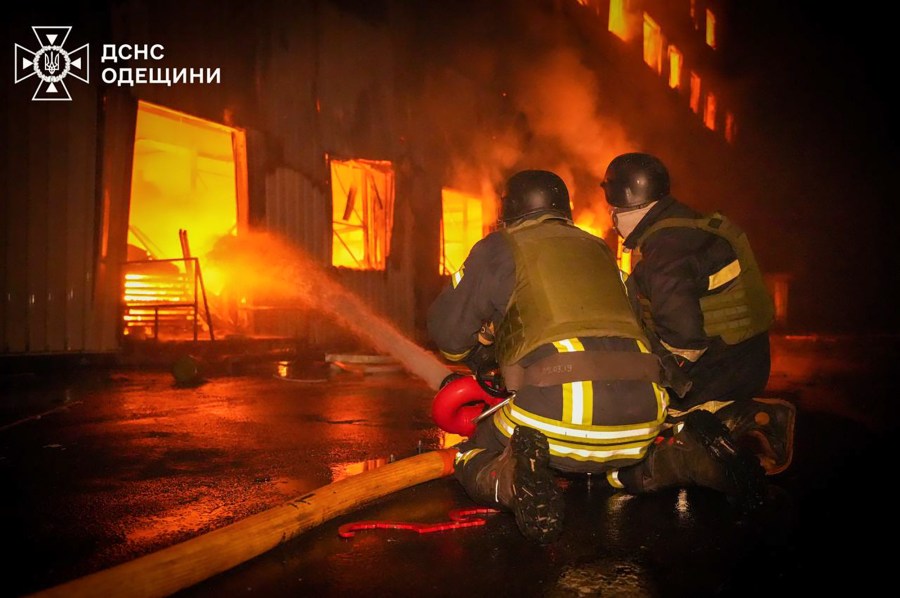 In this photo provided by the Ukrainian Emergency Service, emergency services personnel work to extinguish a fire following a Russian attack in Odesa, Ukraine, Wednesday, May 1, 2024. (Ukrainian Emergency Service via AP)