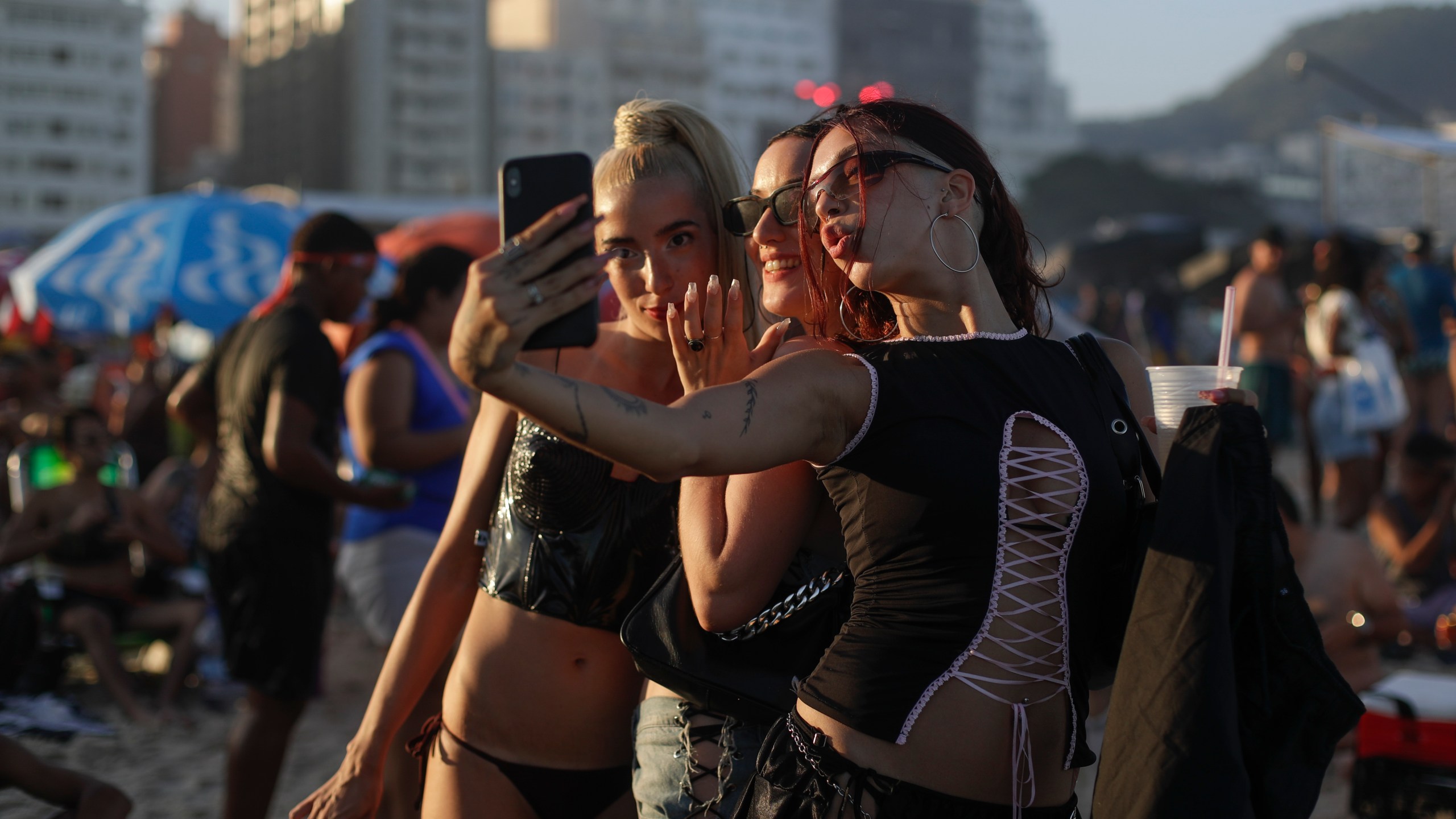 Fans take a selfie as they wait for the start of Madonna's last show of The Celebration Tour, on Copacabana beach in Rio de Janeiro, Brazil, Saturday, May 4, 2024. (AP Photo/Bruna Prado)